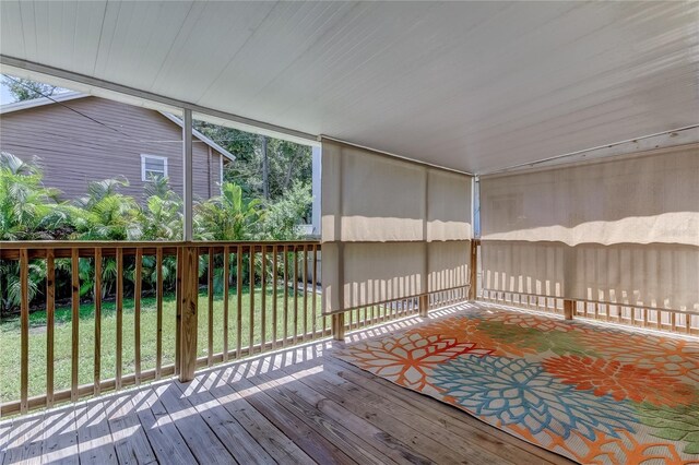 wooden terrace featuring a yard