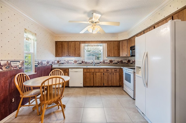 kitchen featuring white appliances, light tile patterned floors, and plenty of natural light