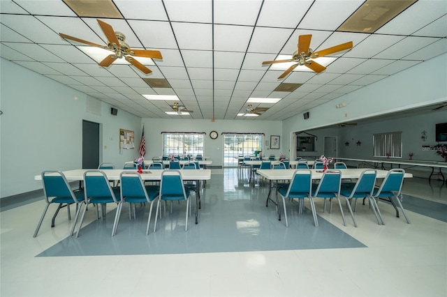 dining room with ceiling fan, a paneled ceiling, and tile patterned flooring