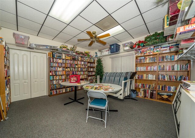 interior space featuring carpet and a drop ceiling