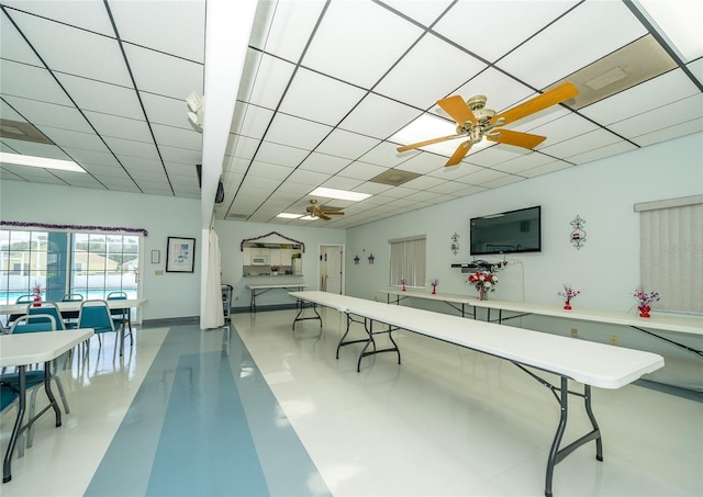 recreation room featuring ceiling fan, light tile patterned flooring, and a paneled ceiling