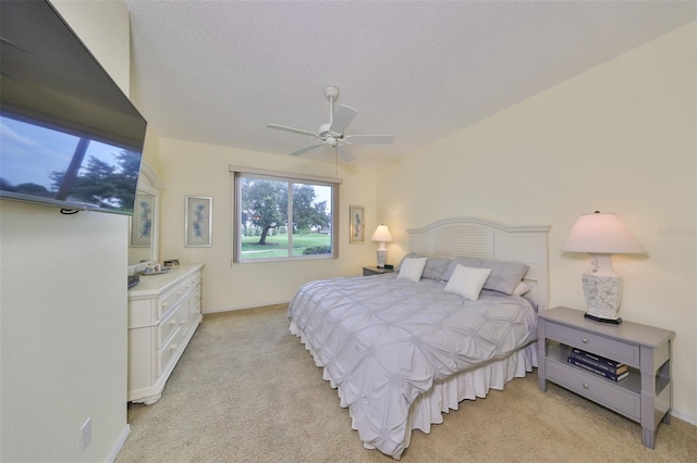 carpeted bedroom with a textured ceiling and ceiling fan