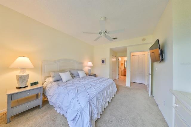 bedroom featuring ceiling fan, a closet, and light carpet