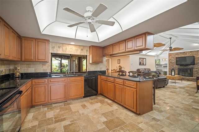 kitchen featuring kitchen peninsula, sink, ceiling fan, and black appliances