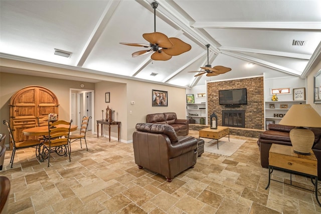 living room featuring lofted ceiling with beams, a brick fireplace, and ceiling fan