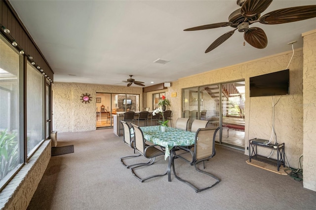 dining room with ceiling fan and carpet