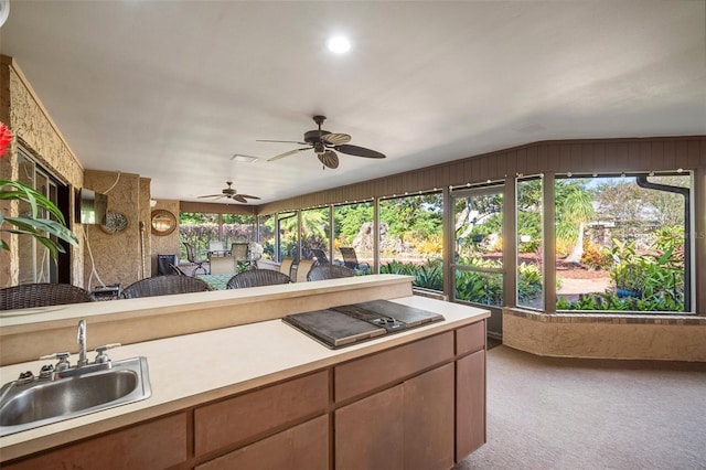 view of patio with ceiling fan and sink