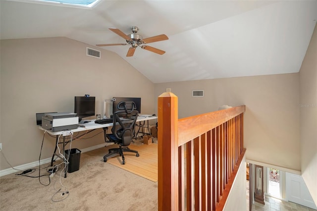 carpeted office space with ceiling fan and vaulted ceiling