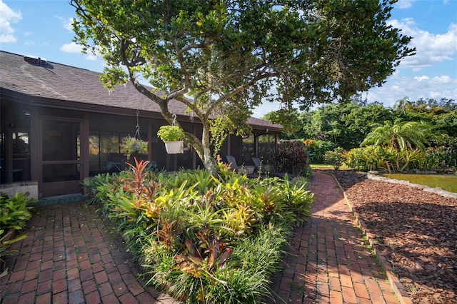 view of yard featuring a sunroom