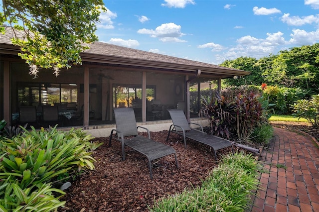 view of patio / terrace featuring a sunroom