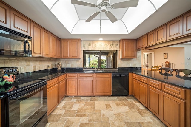 kitchen with dark stone countertops, ceiling fan, sink, and black appliances