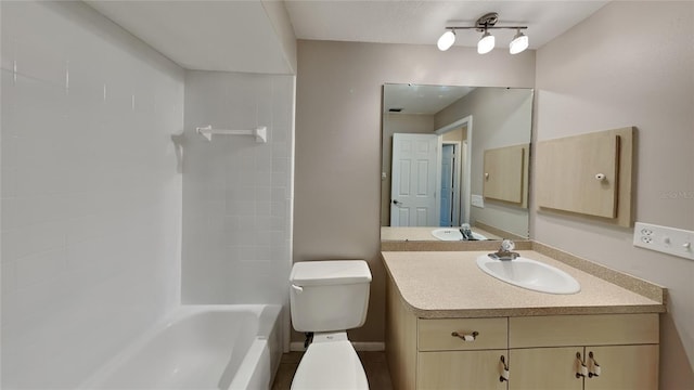 bathroom with tub / shower combination, vanity, and toilet