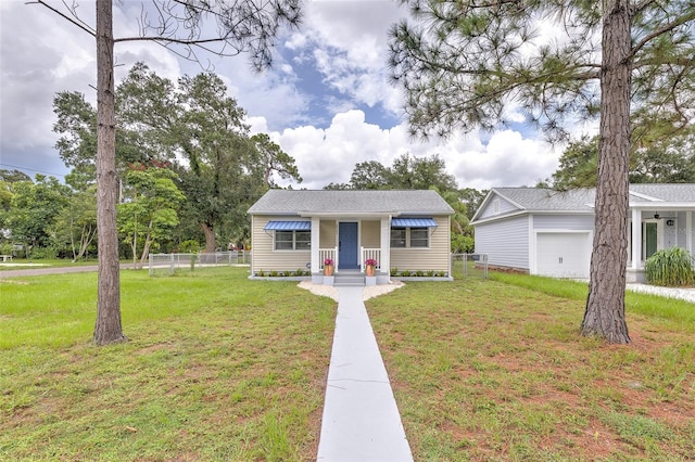 view of front of property with a garage and a front lawn