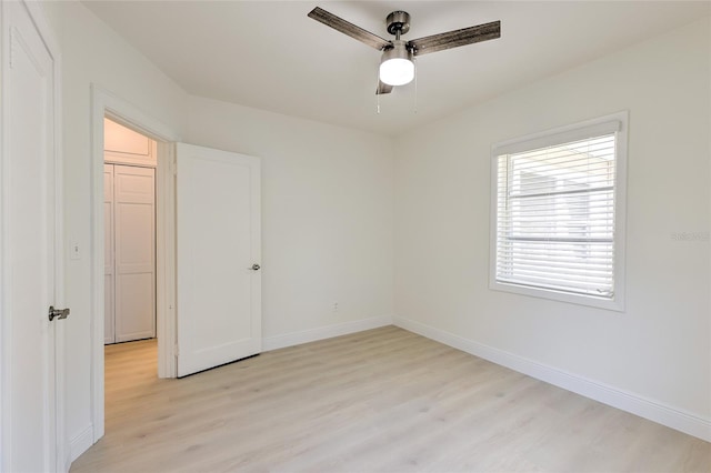 spare room with light hardwood / wood-style flooring and ceiling fan