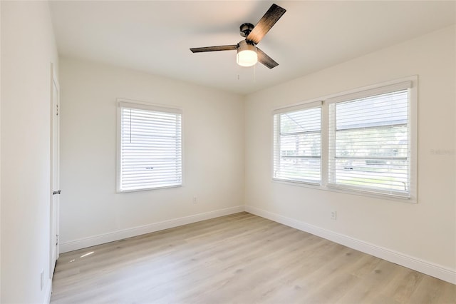 empty room with ceiling fan and light wood-type flooring