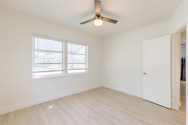 spare room featuring ceiling fan, plenty of natural light, and light hardwood / wood-style floors