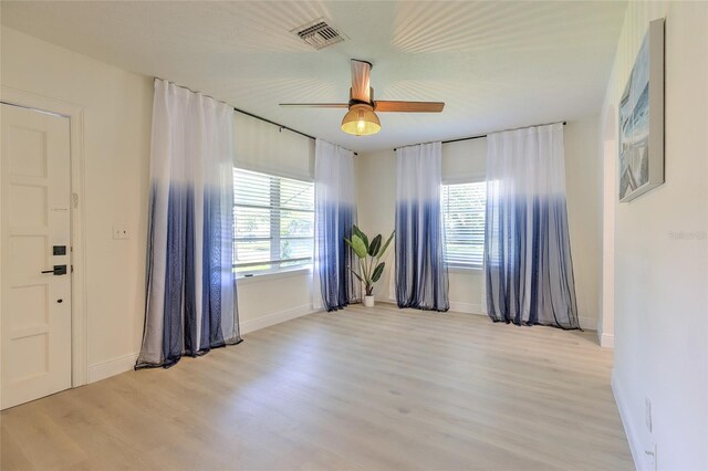 spare room featuring ceiling fan and light wood-type flooring