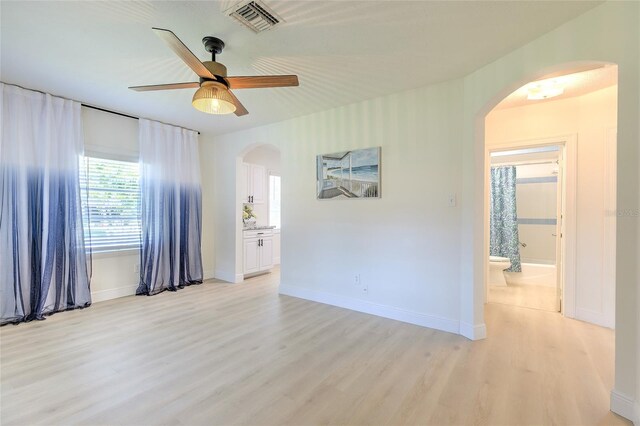 spare room featuring light wood-type flooring and ceiling fan