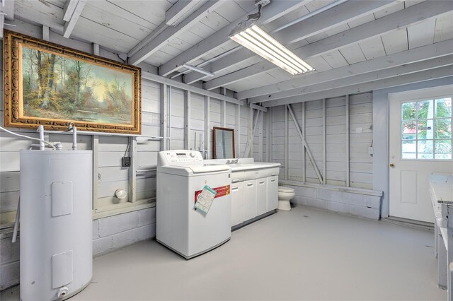 interior space featuring sink, electric water heater, and separate washer and dryer