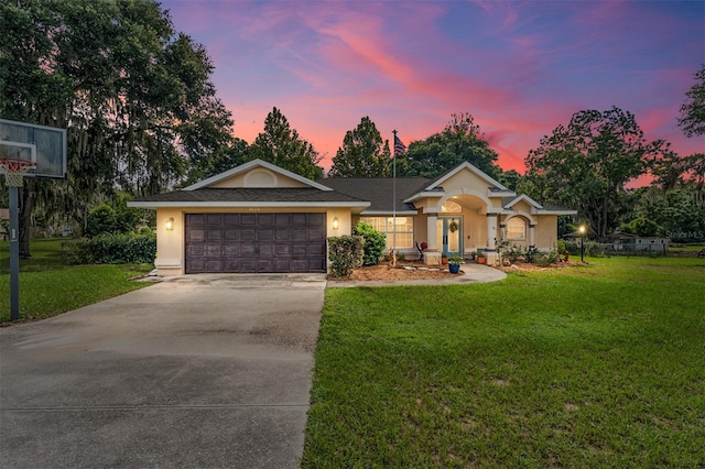 ranch-style house with a lawn and a garage