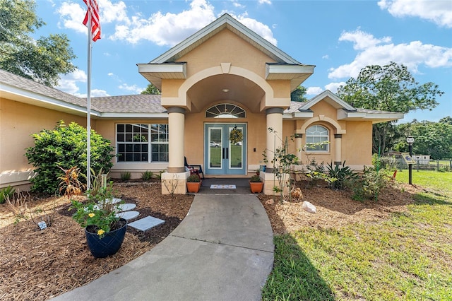 view of front of home featuring a front yard and french doors