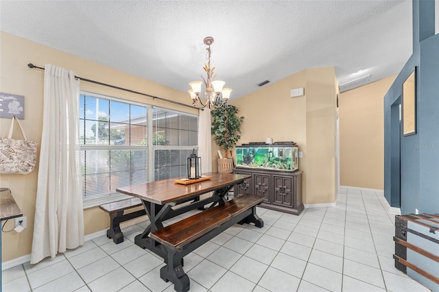 tiled dining space with a textured ceiling, vaulted ceiling, and a notable chandelier