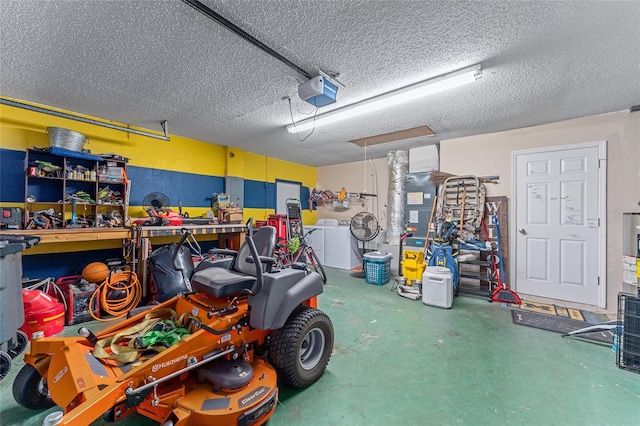 garage featuring a garage door opener, a workshop area, and washing machine and clothes dryer