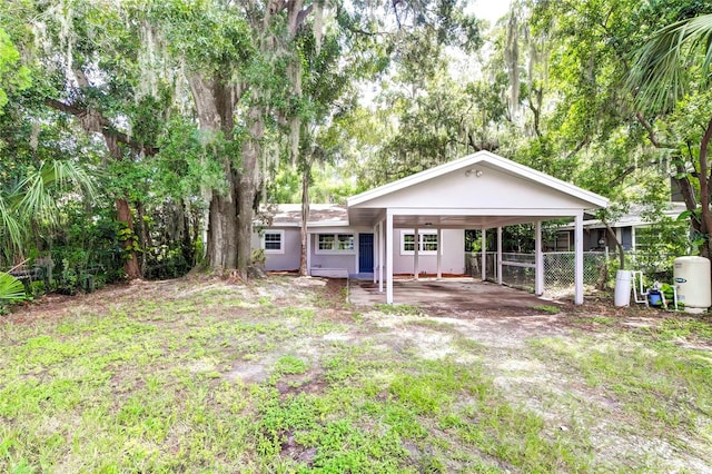 back of property with a carport