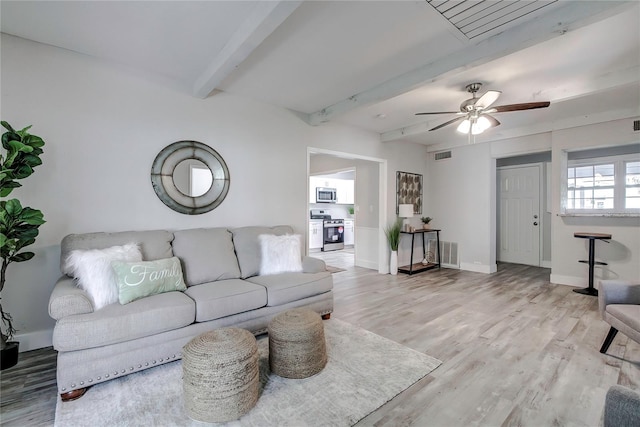 living room featuring ceiling fan, beamed ceiling, and light hardwood / wood-style flooring