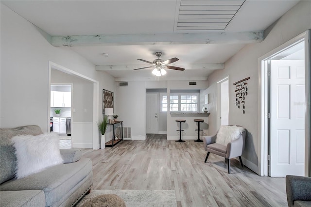 living room with ceiling fan, beam ceiling, and light hardwood / wood-style floors