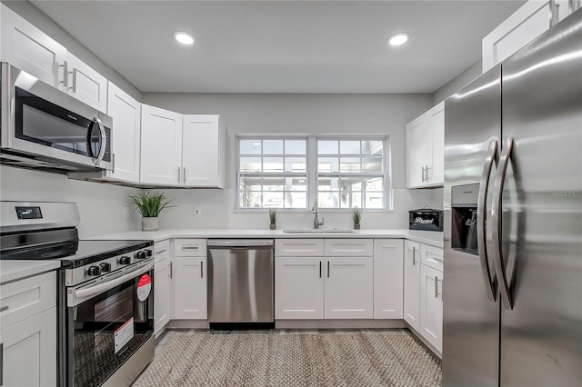 kitchen featuring sink, white cabinets, and stainless steel appliances