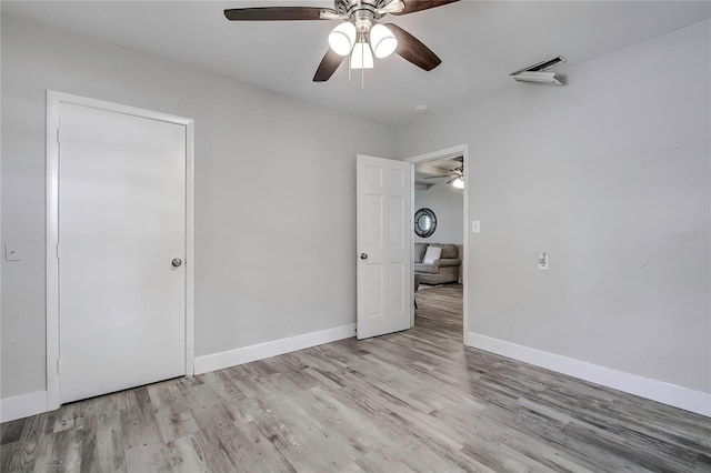 unfurnished bedroom featuring light hardwood / wood-style flooring and ceiling fan