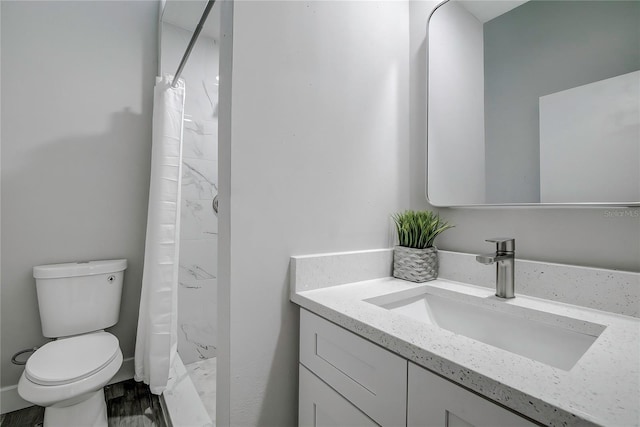 bathroom featuring wood-type flooring, curtained shower, vanity, and toilet