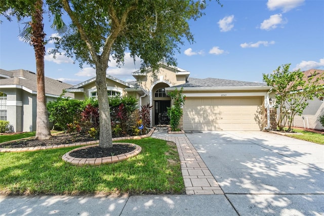 view of front of property with a garage, concrete driveway, and stucco siding