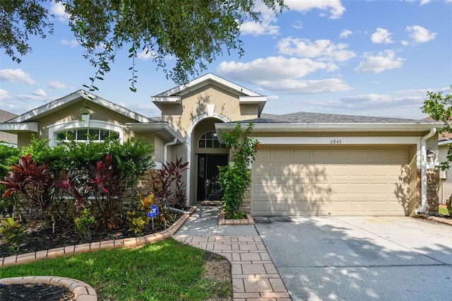 6843 Runner Oak Dr, Wesley Chapel, FL 33545 - view of front of property featuring driveway, an attached garage, and stucco siding