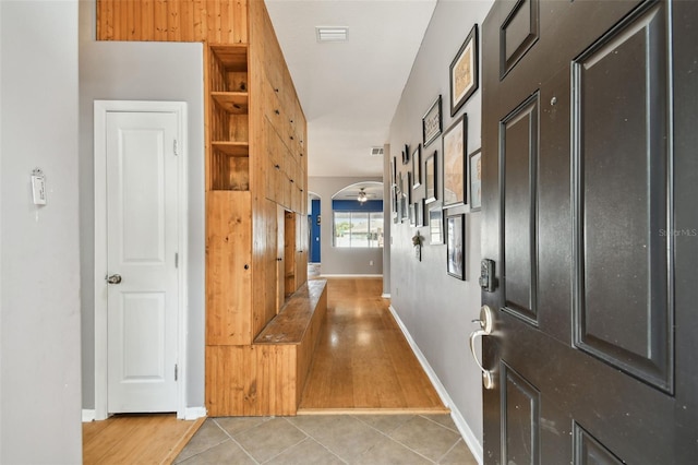 6843 Runner Oak Dr, Wesley Chapel, FL 33545 - corridor with light tile patterned floors, visible vents, and baseboards