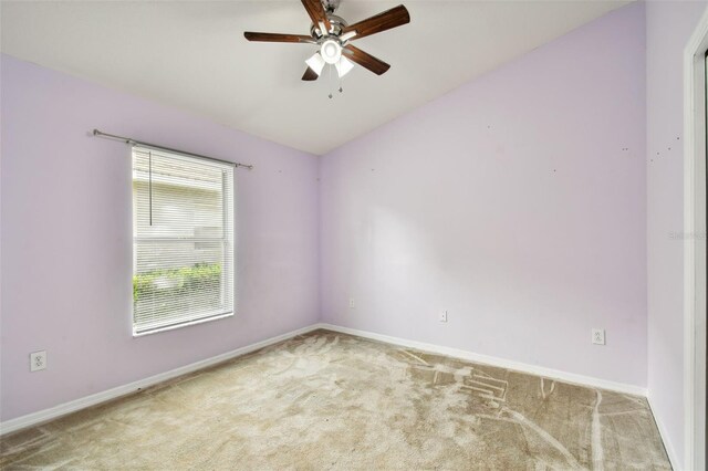 spare room featuring carpet flooring, ceiling fan, and lofted ceiling