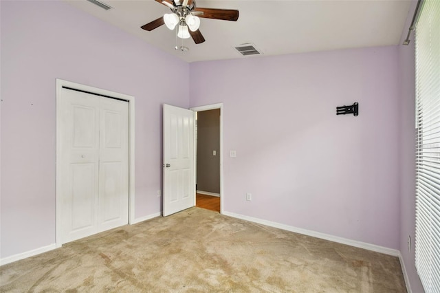 6843 Runner Oak Dr, Wesley Chapel, FL 33545 - unfurnished bedroom with light carpet, baseboards, visible vents, lofted ceiling, and a closet