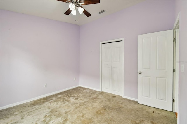 unfurnished bedroom with light colored carpet, a closet, and ceiling fan