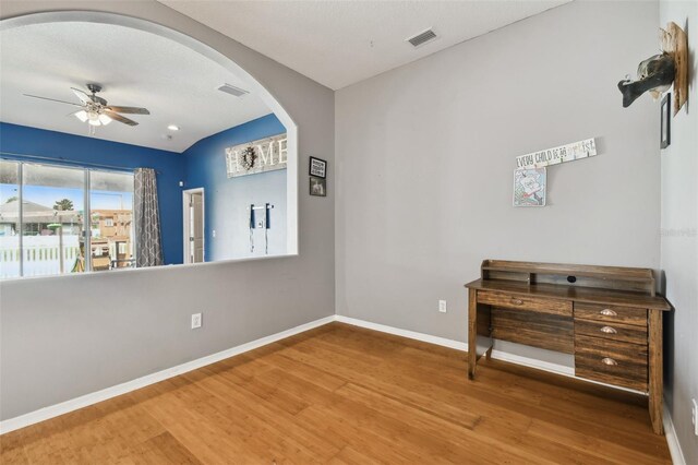 empty room with hardwood / wood-style flooring and ceiling fan