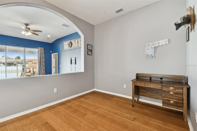 6843 Runner Oak Dr, Wesley Chapel, FL 33545 - interior space with baseboards, visible vents, arched walkways, wood finished floors, and access to outside