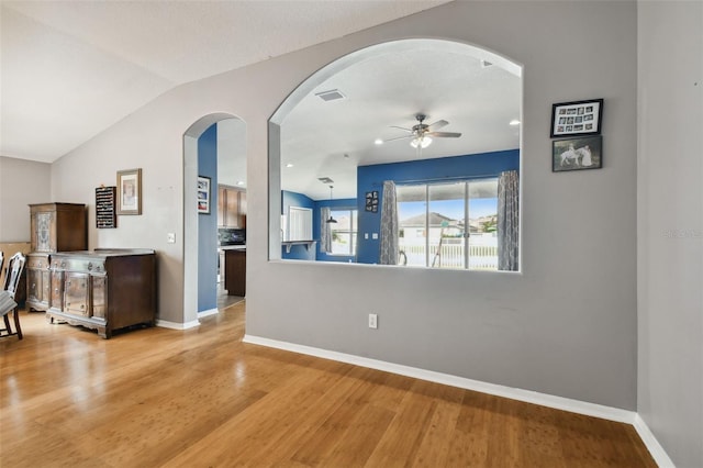 living room featuring hardwood / wood-style flooring, lofted ceiling, and ceiling fan