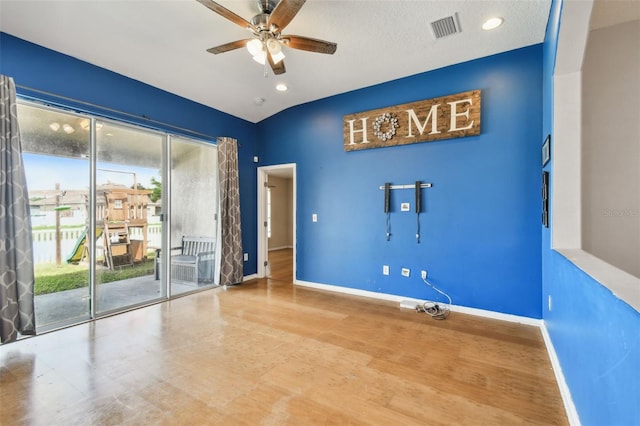 spare room with a textured ceiling, ceiling fan, and lofted ceiling