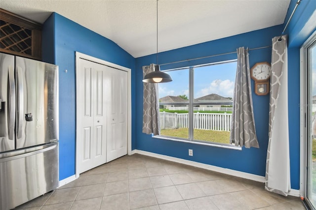 6843 Runner Oak Dr, Wesley Chapel, FL 33545 - unfurnished dining area with a textured ceiling, tile patterned flooring, and baseboards