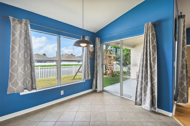 6843 Runner Oak Dr, Wesley Chapel, FL 33545 - unfurnished dining area with vaulted ceiling, tile patterned flooring, and baseboards