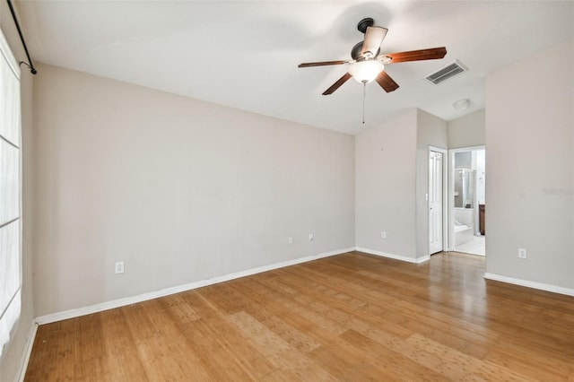 6843 Runner Oak Dr, Wesley Chapel, FL 33545 - empty room featuring a ceiling fan, wood finished floors, visible vents, and baseboards