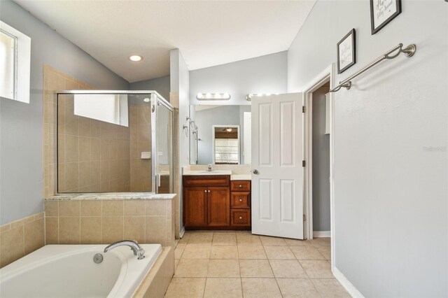 bathroom featuring tile patterned floors, vaulted ceiling, separate shower and tub, and vanity