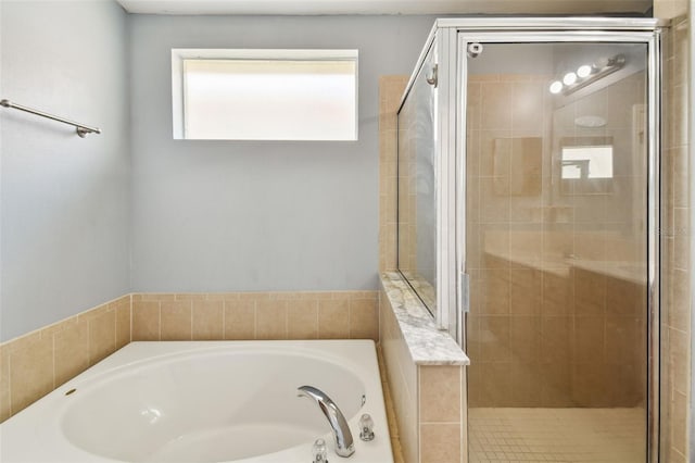 bathroom with separate shower and tub