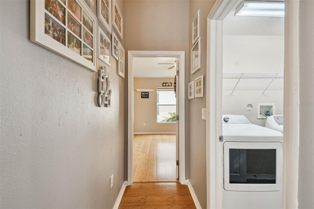 washroom with hardwood / wood-style floors and washing machine and dryer