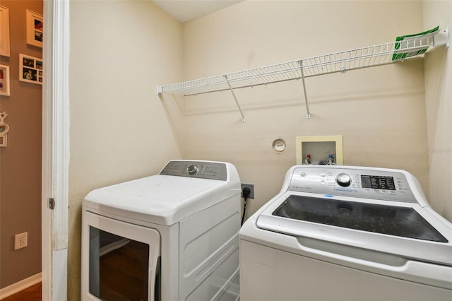 laundry room with washing machine and clothes dryer